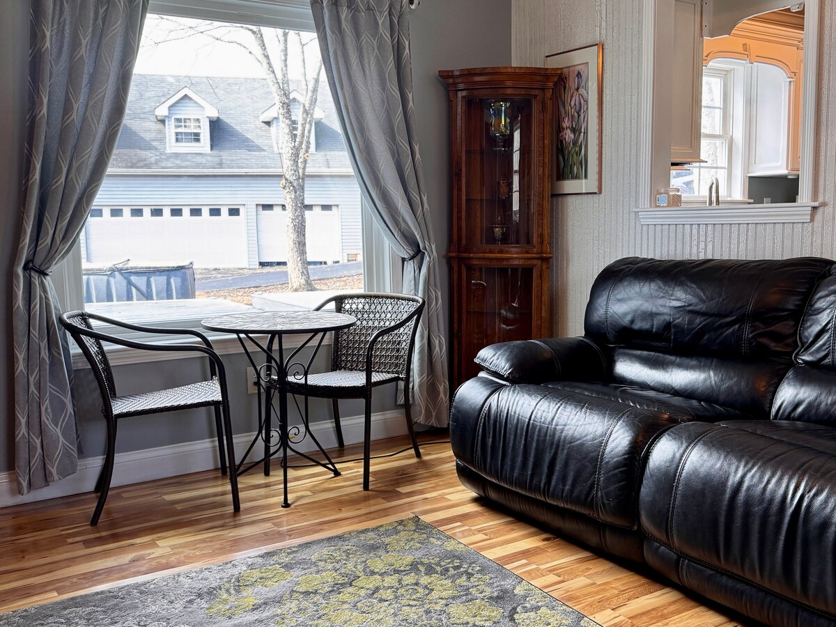Living room with an electric recliner couch and a bistro table at the bay window
